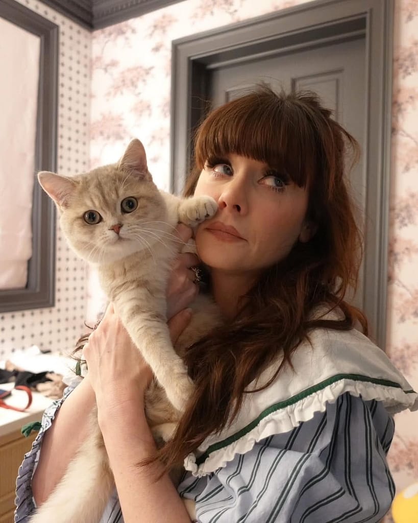Zooey Deschanel Shares 3 Surprising Things About ‘Merv’ — Including Why She Didn’t Think It Was a Christmas Movie 1 Zooey Deschanel